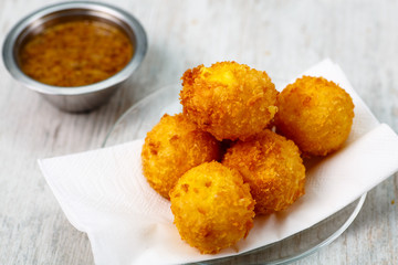 Lay the croquettes on a plate with red sauce. Big.