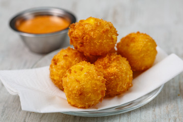 Lay the croquettes on a plate with red sauce. Big.