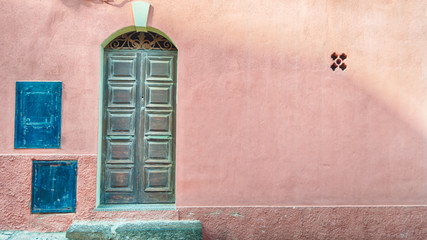 old door on pink wall with copy space