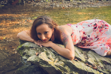 young pretty woman on a rock