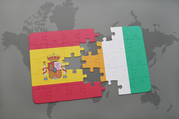 puzzle with the national flag of spain and cote divoire on a world map background. © luzitanija