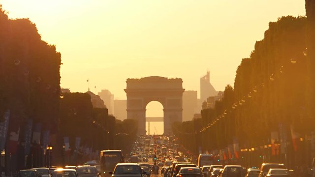 traffic jam champs elysees avenue paris france at the sunset  Triumphal Arch warm color people come back from work 