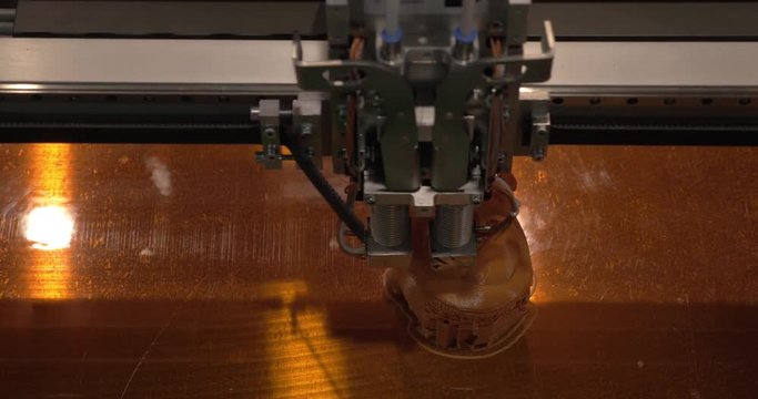 In ECC Sokolniki, Moscow at exhibition of 3D Expo seen close-up of mechanism of 3D printer working on printing plastic toys. Printing technology