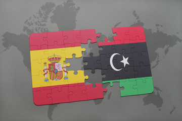 puzzle with the national flag of spain and libya on a world map background.
