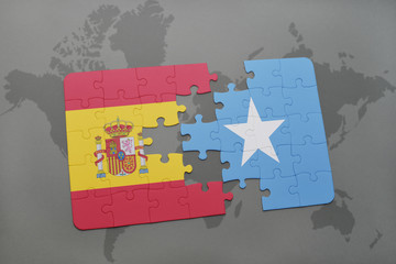 puzzle with the national flag of spain and somalia on a world map background.