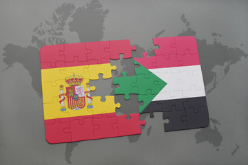 puzzle with the national flag of spain and sudan on a world map background.