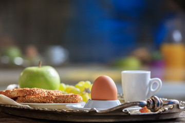Breakfast with fresh fruits, boiled egg and coffee