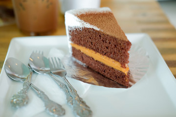 piece of chocolate cake with milk tea on the table