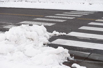 winter road with snow removed and piled aside