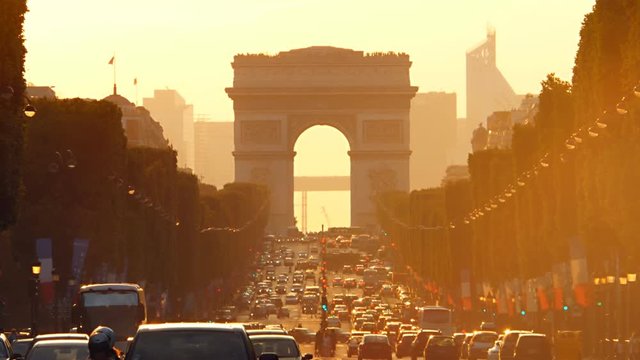 Paris 01 july:traffic jam champs elysees avenue paris france at the sunset  Triumphal Arch warm color people come back from work