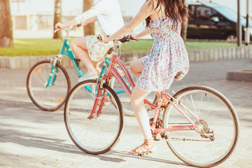 The two young girls with bicycles in park