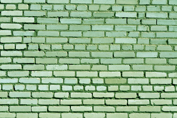 Weathered green brick wall texture.