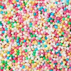 Fototapeta na wymiar Colorful sugar sprinkle dots, decoration for confectionery. Candy background. Top view