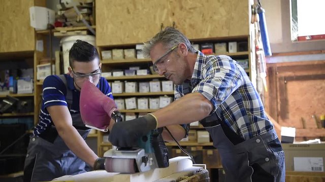 Carpenter with apprentice in training period