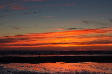Fototapeta na wymiar Colourful sunset over the beach at Polzeath