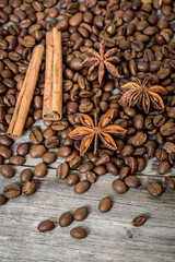 Coffee, cinnamon and Damian on wooden background