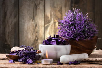 spa massage setting, lavender product, oil on wooden background