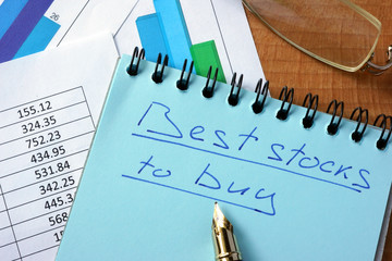 Notepad with inscription  best stocks to buy on a table.