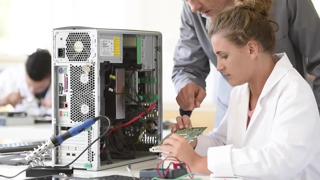 Student in electrical engineering course training with teacher