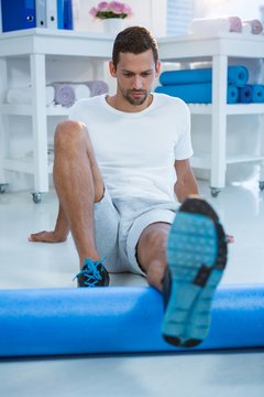 Man Performing Exercise Using Foam Roll