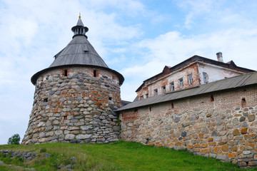 Ancient monastery tower and fragment of wall