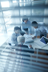 Four business people planning in office