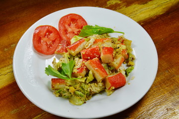 stir fried cabbage with crab stick and egg on dish
