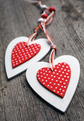 White and red sewed christmas hearts on wooden background,  for greetings Valentine's  day