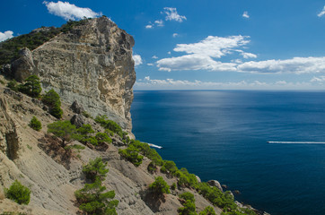 Yacht in the sea on blue sky background. Top view of Blue Bay and the mountains on the Black sea coast. Crimea.