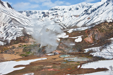 Tourists during the tour at the thermal field in the Valley of G