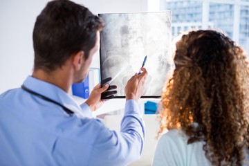 Physiotherapist explaining x-ray to patient