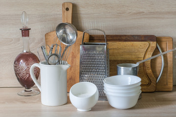 Crockery, tableware, utensils and other different stuff on wooden table-top.Kitchen still life as background for design.  Image with copy space.