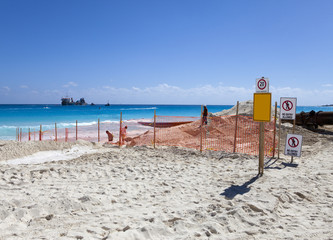  laying new sand on the beach. Mexico...