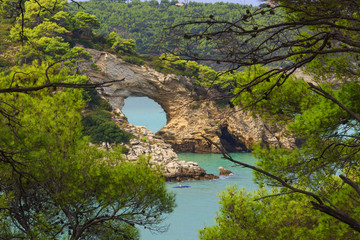 Fototapeta na wymiar Gargano coast: San Felice arch (Architello), Italy.Gargano National Park,Vieste.The little rock arch is spectacular symbol of Vieste.