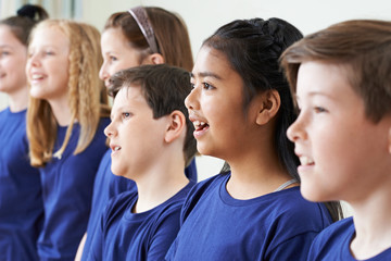 Group Of School Children Singing In Choir Together