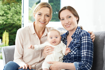 Obraz premium Portrait Of Mother With Adult Daughter And Baby