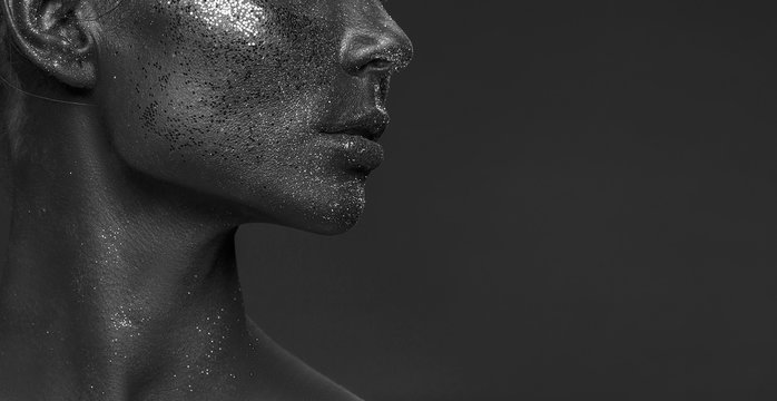 Close-up neck and lips of young girl with creative ogue style make-up. Black and white.