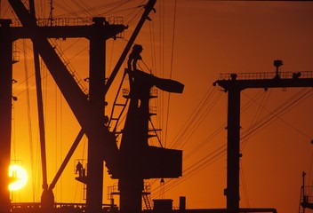 Worker in the middle of gigantic porticos (photo without special effects). Nantes-Saint Nazaire. France
