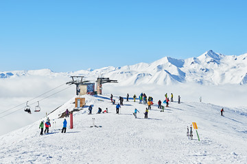 Skiers and snowboarders are on the top of the mountain in Gudauri, Geogria, near the ski lifts in February 2016