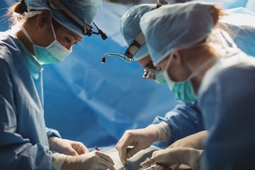 Surgeons performing operation in operation room