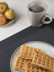 Waffles tea and apples for breakfast.