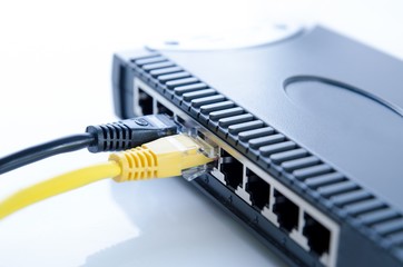 Network switch device and ethernet cables on white