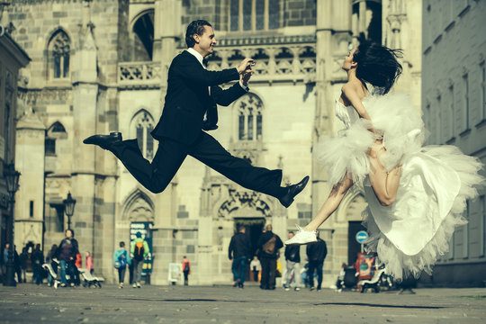 wedding happy couple jumping near castle