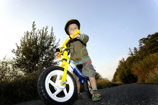 Baby Boy Riding On His First Bike. Bike Without Pedals. Child Learning To Ride And Balance On His Two Wheeler Bike With No Pedals.