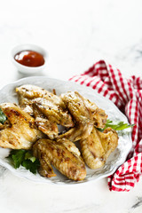 Baked chicken wings with parsley and tomato sauce
