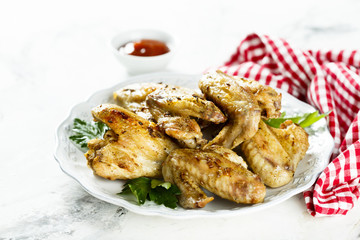 Baked chicken wings with parsley and tomato sauce