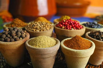 Collection of different spices in old clay bowls in colorful oriental style