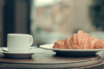 Fresh croissant and coffee cup