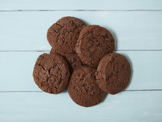 Aerial view of chocolate chip cookies on a blue wooden counter top background