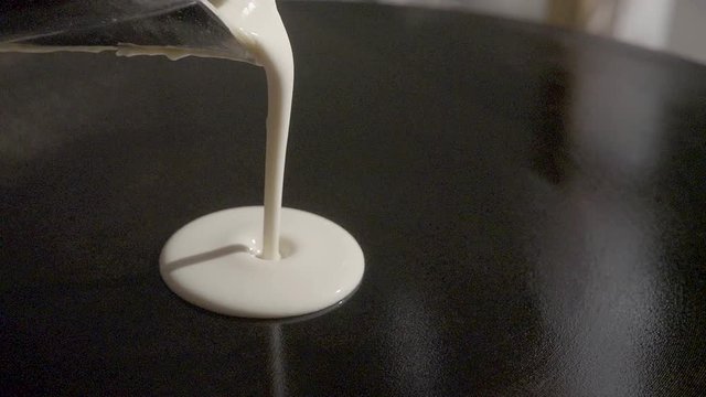 Slow-motion. Dough pour on crepes / pancake maker. SLOG3, close-up.